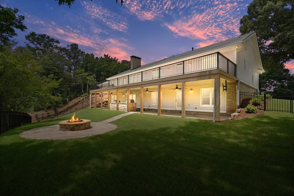 Outdoor living space with fire pit at dusk