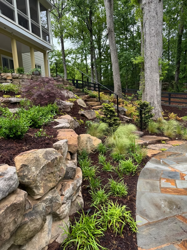 Boulder planting bed with stone walkway