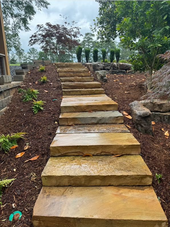 Natural stone slab steps through a planted slope